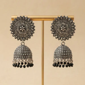 Front view of antique silver sunburst jhumka earrings with black bead drops by Applique Threads.